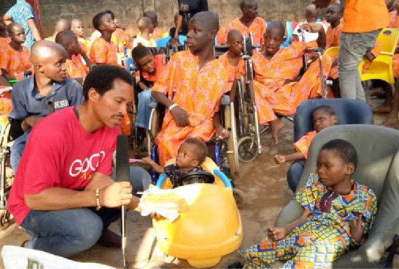 a man is helping a group of children play