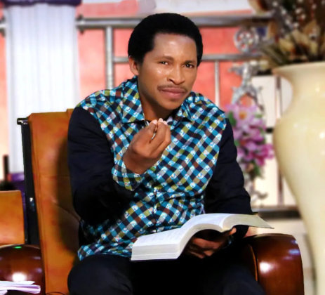 A man in a plaid shirt is sitting in a brown leather chair.